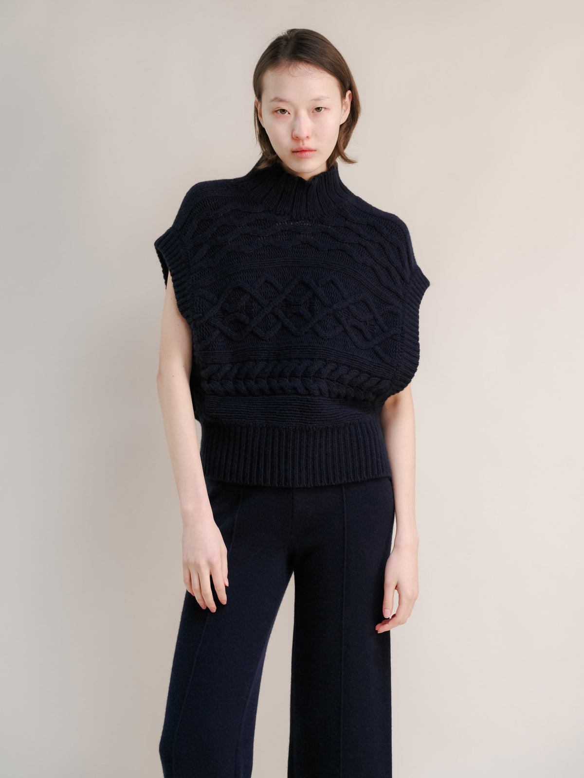 Navy cashmere mix Maxi-Zopfstricktunika on a model featuring a chunky knit pattern and gerippter Saum with a hoher Kragen.