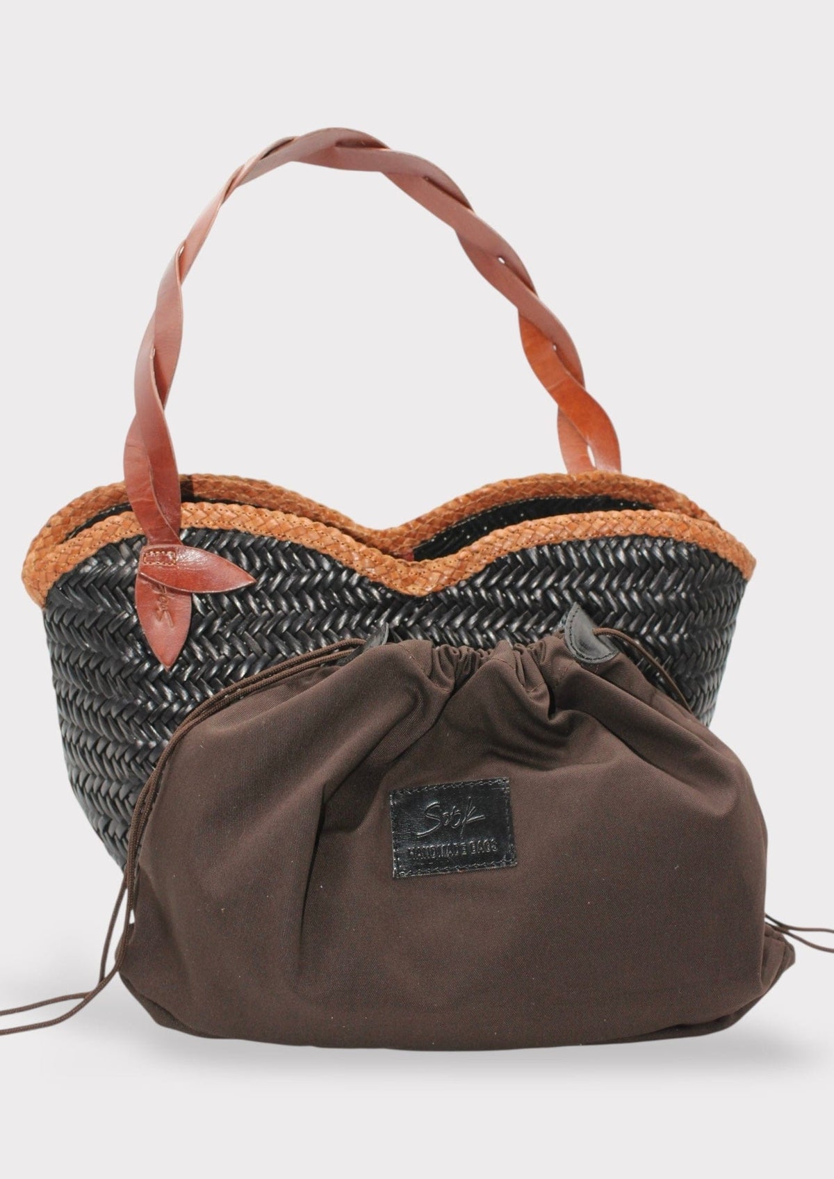 Léafa - Handwoven Leather Shoulder Bag | Brown & Black featuring twisted leather handles and woven basket-style body with fabric pouch inside.
