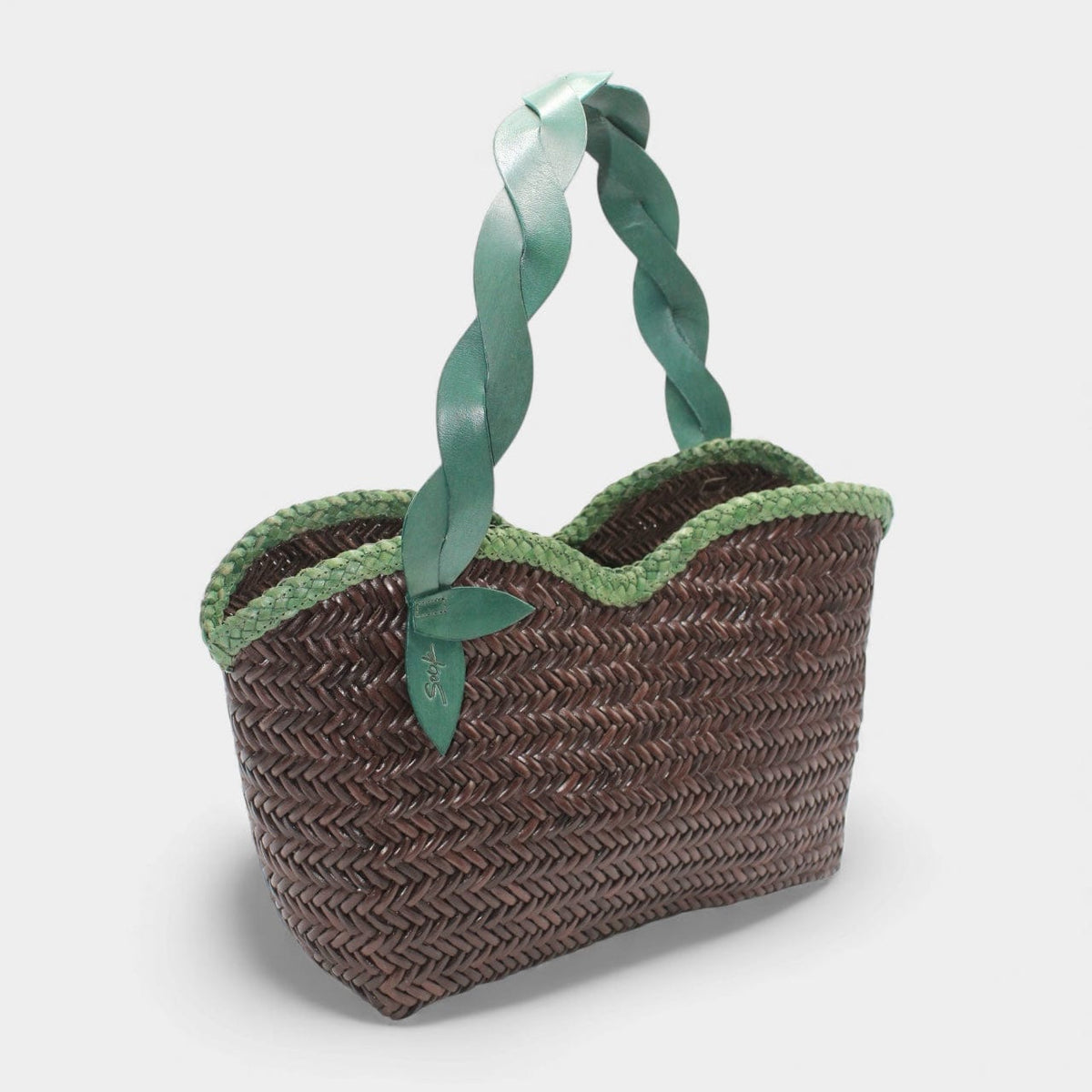 Léafa - Handwoven Leather Shoulder Bag | Vert & Café featuring braided green leather handles and dark woven leather body with scalloped trim.