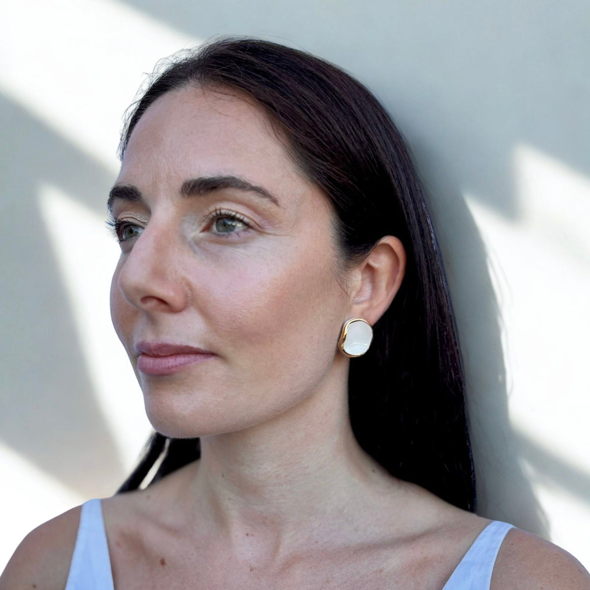 Femme porcognact white and gold ceramic earrings with a white top with a neutral background