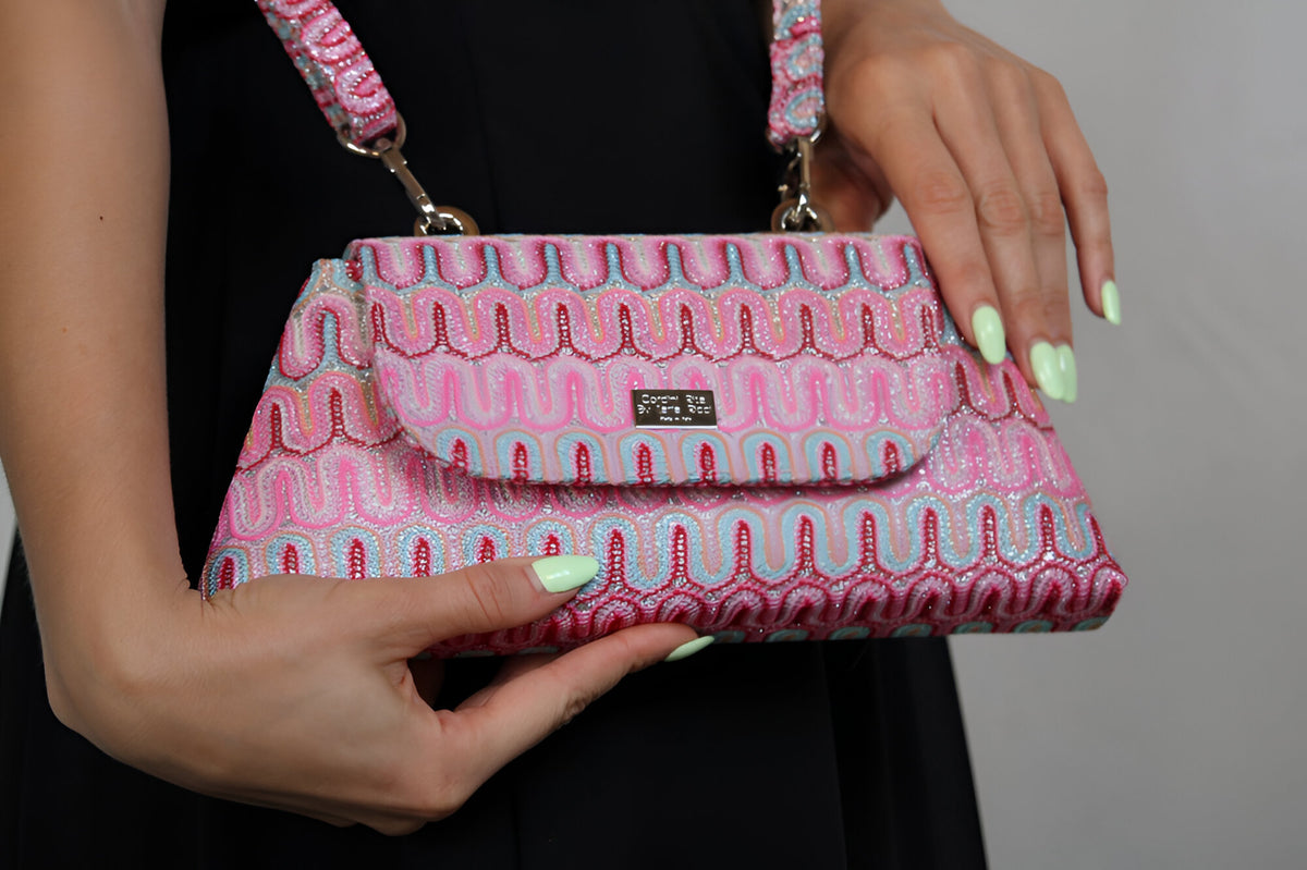 Pink patterned handbag from Cordini Rita haute couture collection with a wavy design