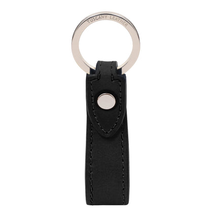 A black leather keychain with a silver-tone metal split ring and snap button closure, featuring the brand name 'TUSCANY LEATHER' engraved on the ring, set against a plain white background.