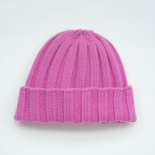 Pink knit beanie on a light gray background