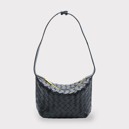 Black woven leather shoulder bag with a long strap and gold zipper.