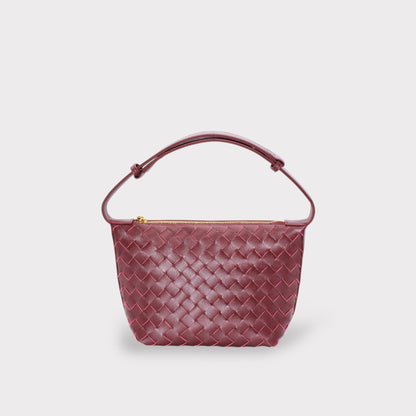 Wine burgundy woven leather boxed pouch bag with an arched top handle and gold zipper.