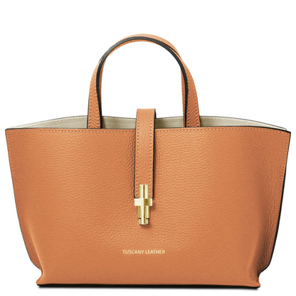 Agatha tan pebbled leather tote with two top handles and a gold center clasp.