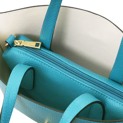 Close-up of turquoise Italian leather tote bag interior showing zippered compartment with gold-tone hardware and smooth lining.
