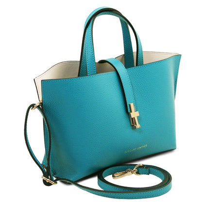 Teal pebbled leather tote with double top handles, detachable shoulder strap, and gold-tone clasp closure detail.