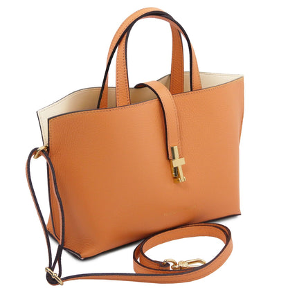 Tan full-grain leather tote purse with double handles, detachable shoulder strap, and gold-tone hardware detail.