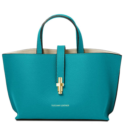 Teal handbag with gold clasp on a white background