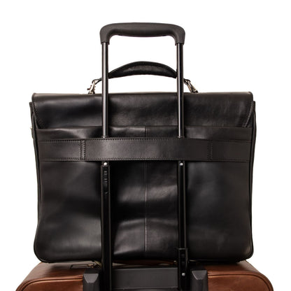 Mat black leather laptop briefcase mounted on a rolling suitcase with an extended telescoping handle