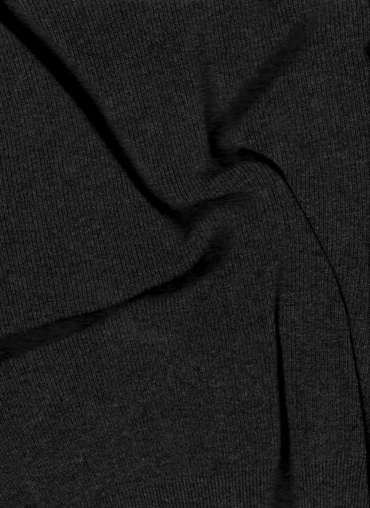 Close-up of dark charcoal knit fabric with visible ribbing and seam details.
