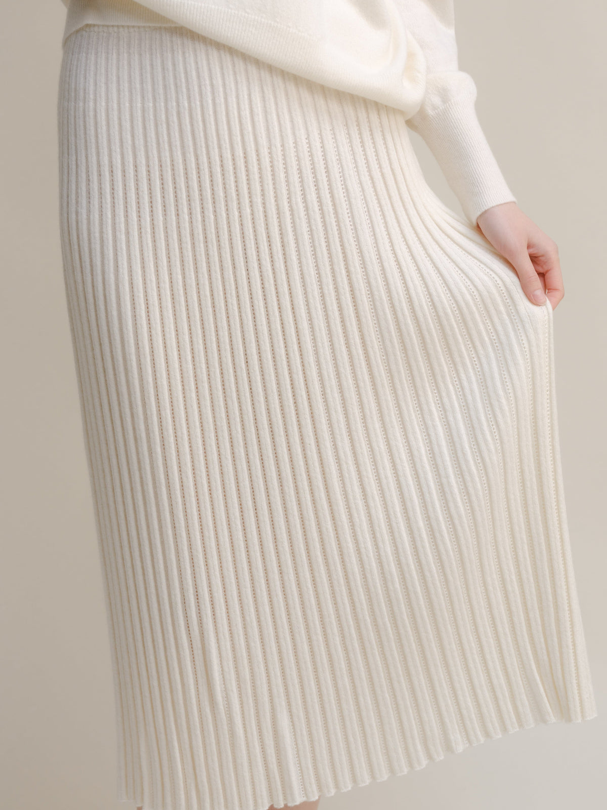 Cream white cashmere blend knit skirt with vertical rib pattern close up