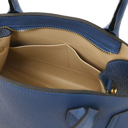 Interior view of Coccola blue leather tote with beige lining, zip closure, and interior pocket divider.