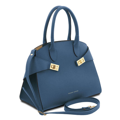 Angled view of blue Coccola tote with pebbled leather and detachable strap