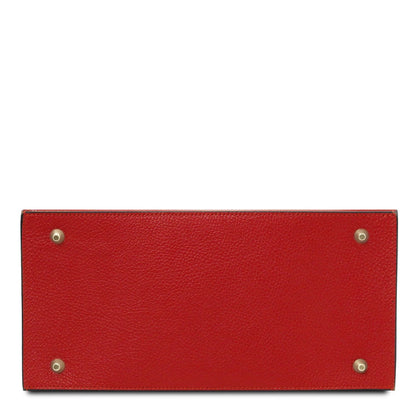 Red leather tote bag bottom with four gold-tone metal studs
