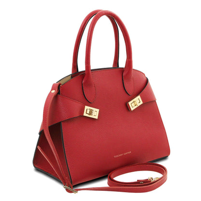 Red leather tote with double top handles and a detachable strap shown at an angle with Tuscany Leather branding.
