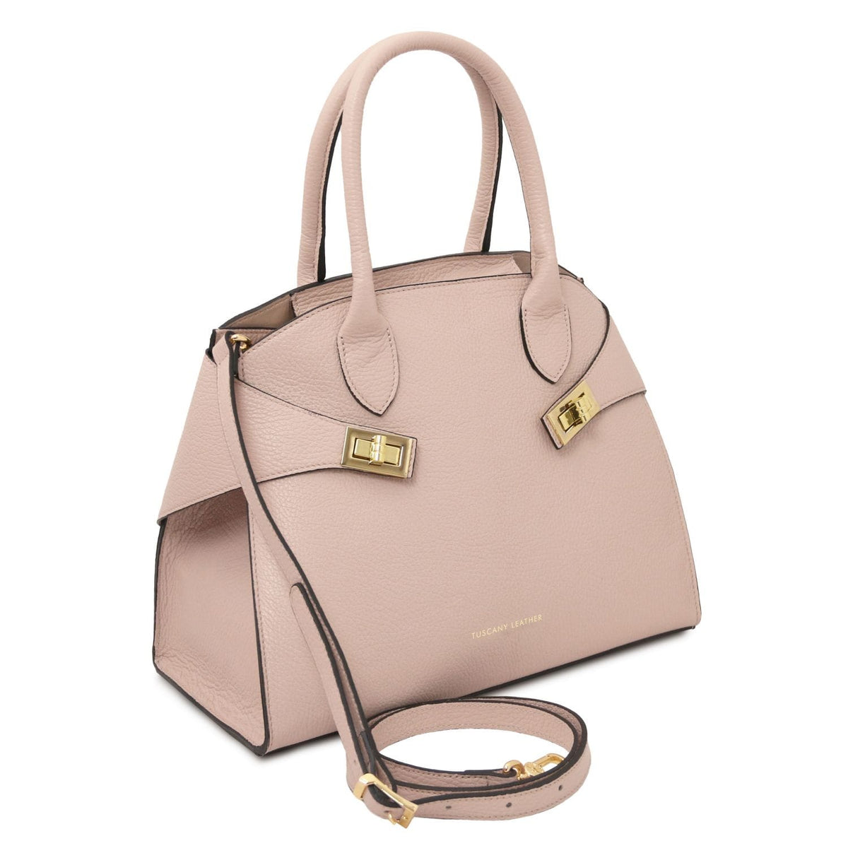 Angled view of pink beige leather tote showing two top handles and a removable crossbody strap with gold hardware