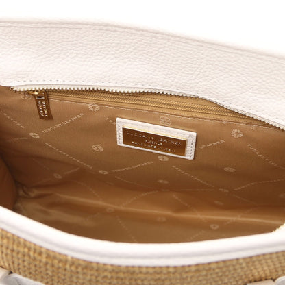 Inside view of Frame straw effect bag with tan lining, zip pocket and gold metal plaque