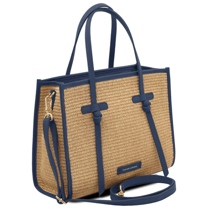 Angled side view of Frame straw effect shoulder bag with blue trim and removable shoulder strap