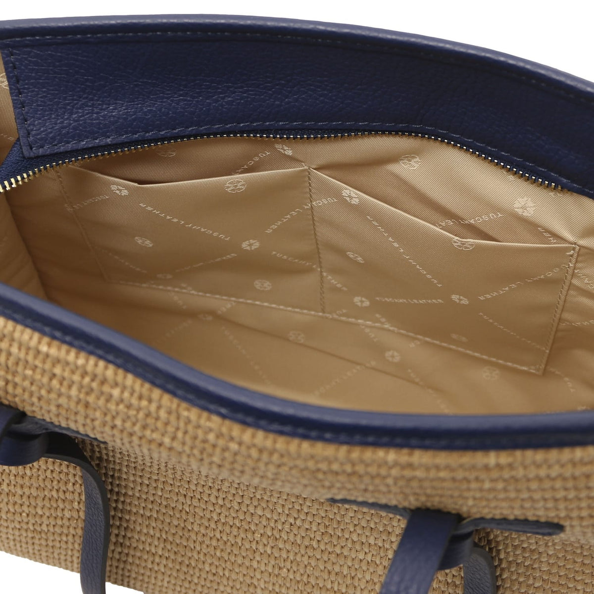Interior view of Frame straw effect shoulder bag with beige lining and small pockets under navy trim