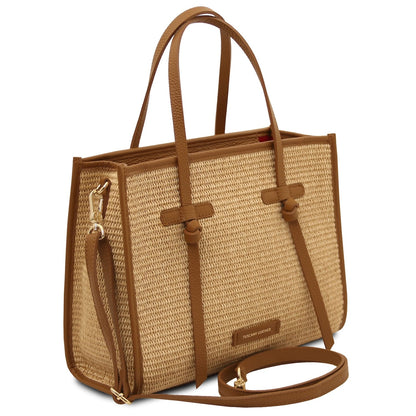 Angled view of Frame straw effect shoulder bag with detachable strap and gold hardware