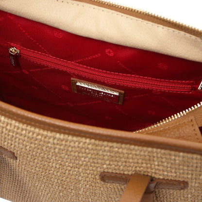 Interior view of the bag with red lining, zip pocket and brand plaque