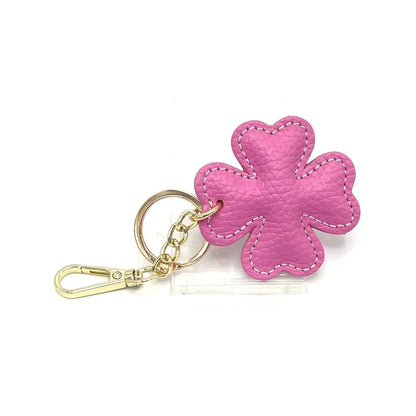 Pink leather four leaf clover bag charm with gold hardware and lobster clasp