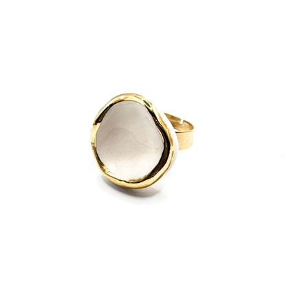 Leda ring displayed from the side showing a white ceramic center with irregular gold edge