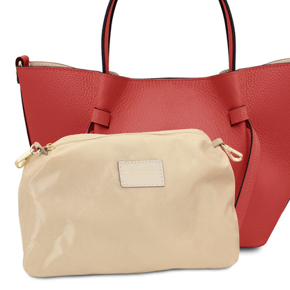 Beige zip pouch displayed in front of the red leather handbag.
