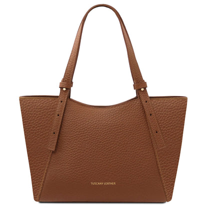 Brown pebbled leather tote with long handles and gold Tuscany Leather lettering on the front.
