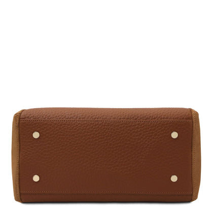 Bottom view of a brown pebbled leather tote with four metal studs