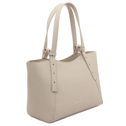 Light beige pebbled leather tote with long double handles and minimalist design.