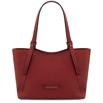 Red leather tote with long double handles and a Tuscany Leather plaque on the front.