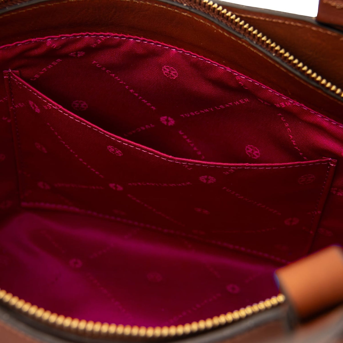 Close up of Libra tote interior showing pink lining and stitched pocket