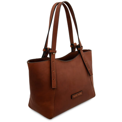 Brown leather tote handbag with a visible brand label on a white background