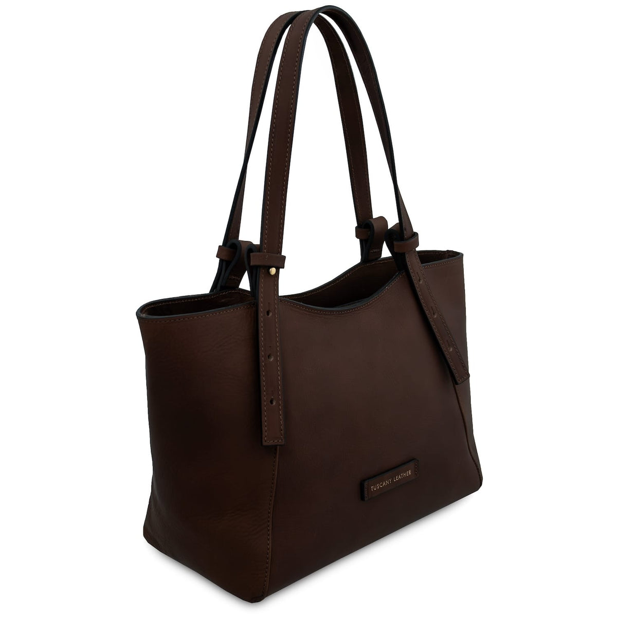 Side angle of a brown leather tote with long adjustable handles and visible stitching.