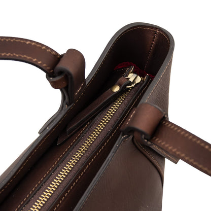 Top close up of Libra leather tote with gold zipper and interior pocket visible