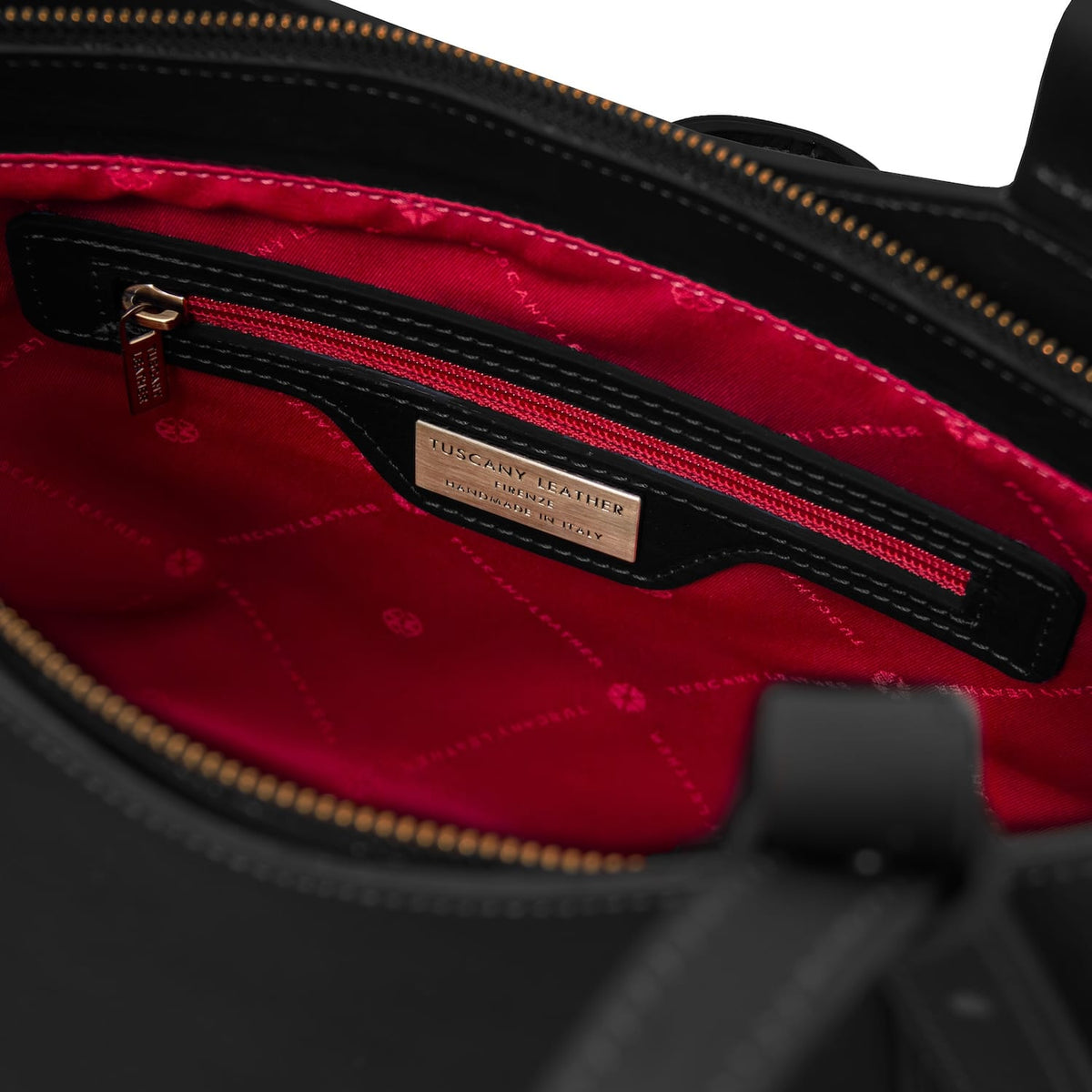 Inside Libra tote with red lining, gold zipper, and Tuscany Leather label.