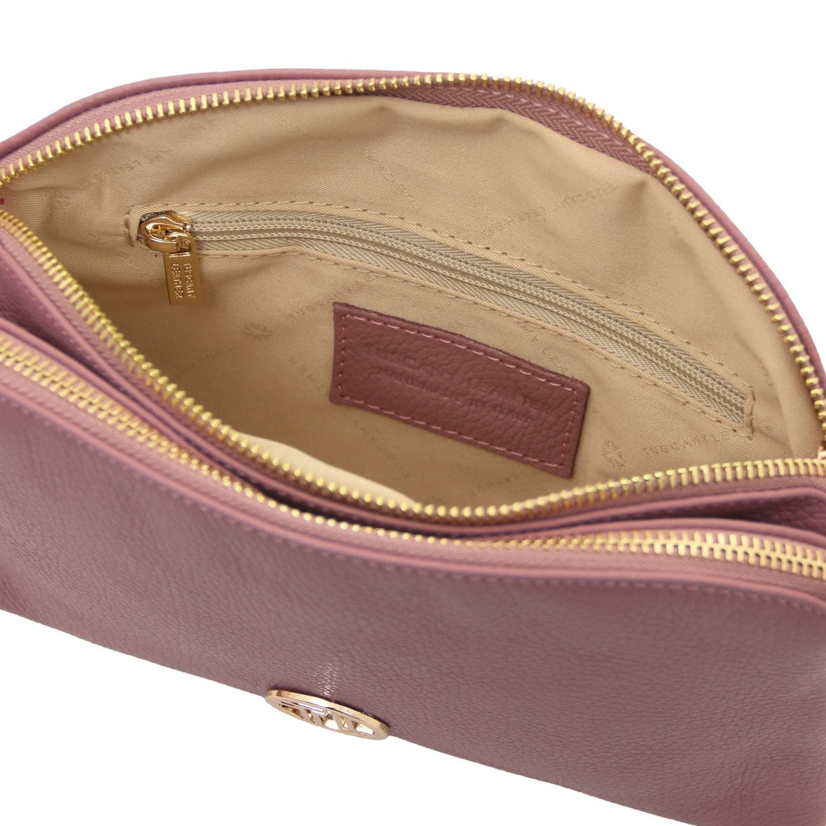 Interior view of Lily bag with beige lining, zip pocket and leather label