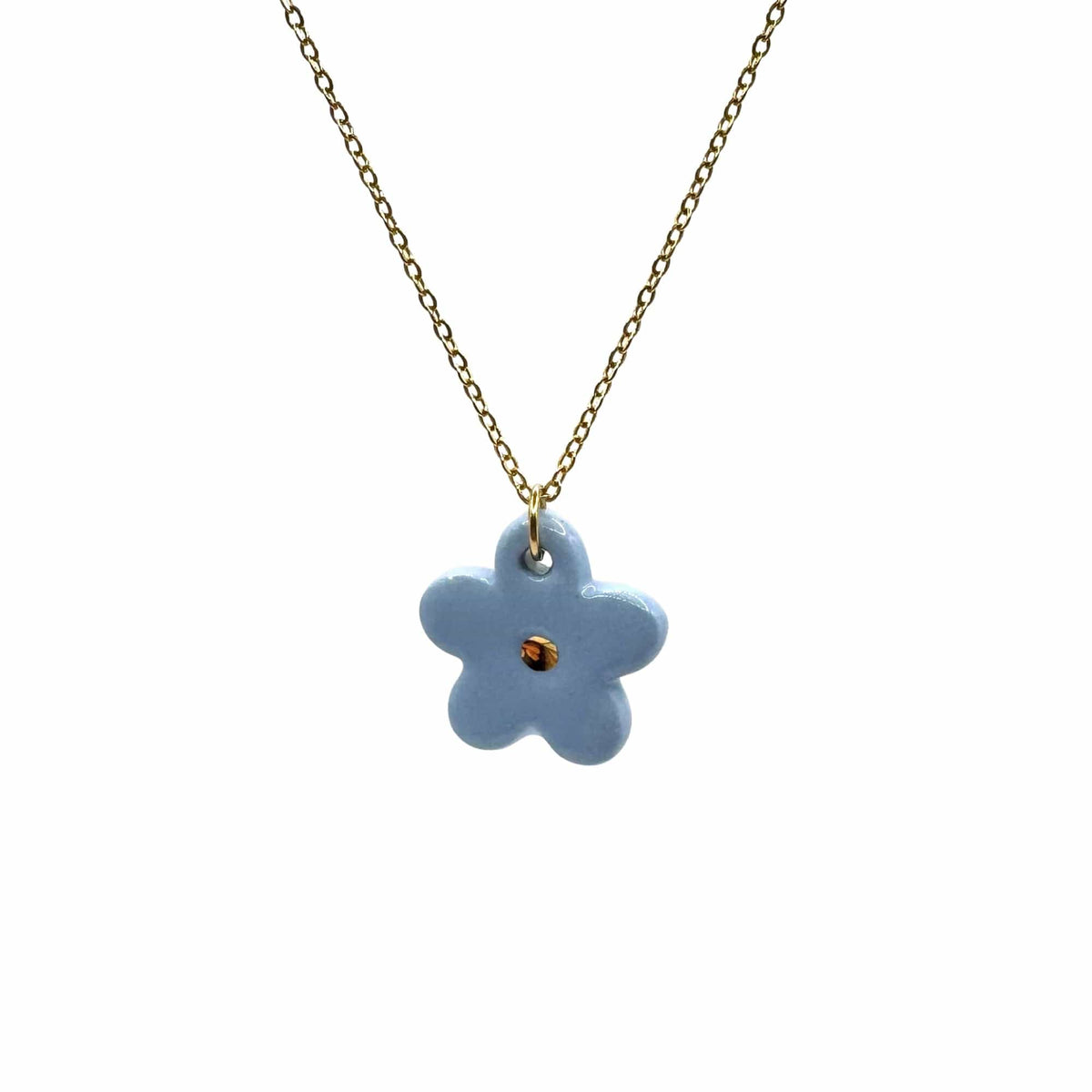 Blu flower ceramic pendant on a gold chain against a bianco background