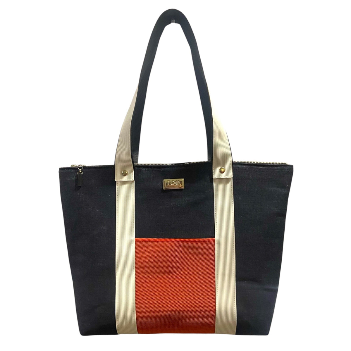 Navy denim, orange, and beige tote bag on a white background