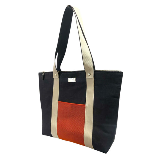 Navy denim tote bag with orange section and beige accents on a white background