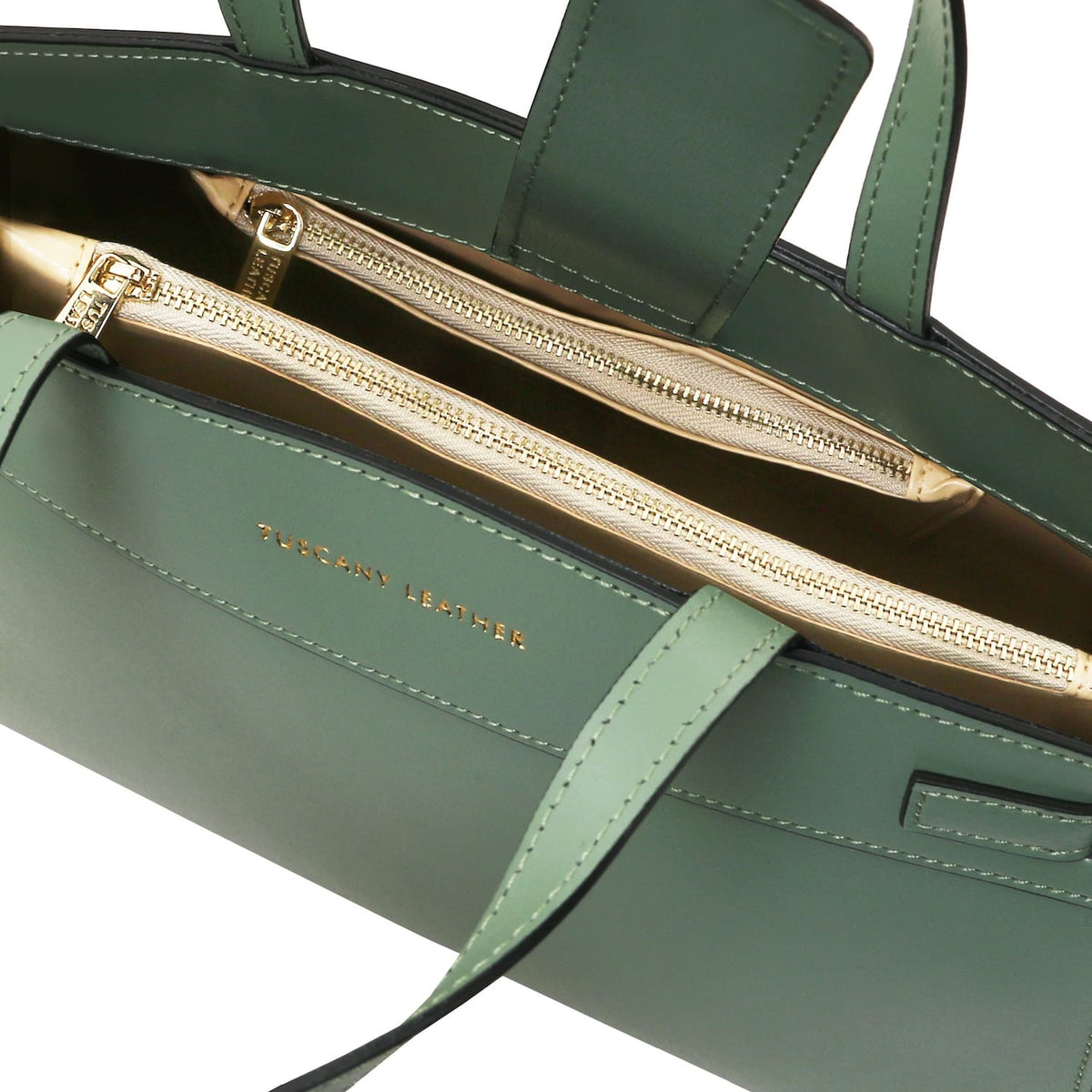 Verde Musa Bolso de piel italiana with cremalleras doradas and beige interior showing two zip compartments.