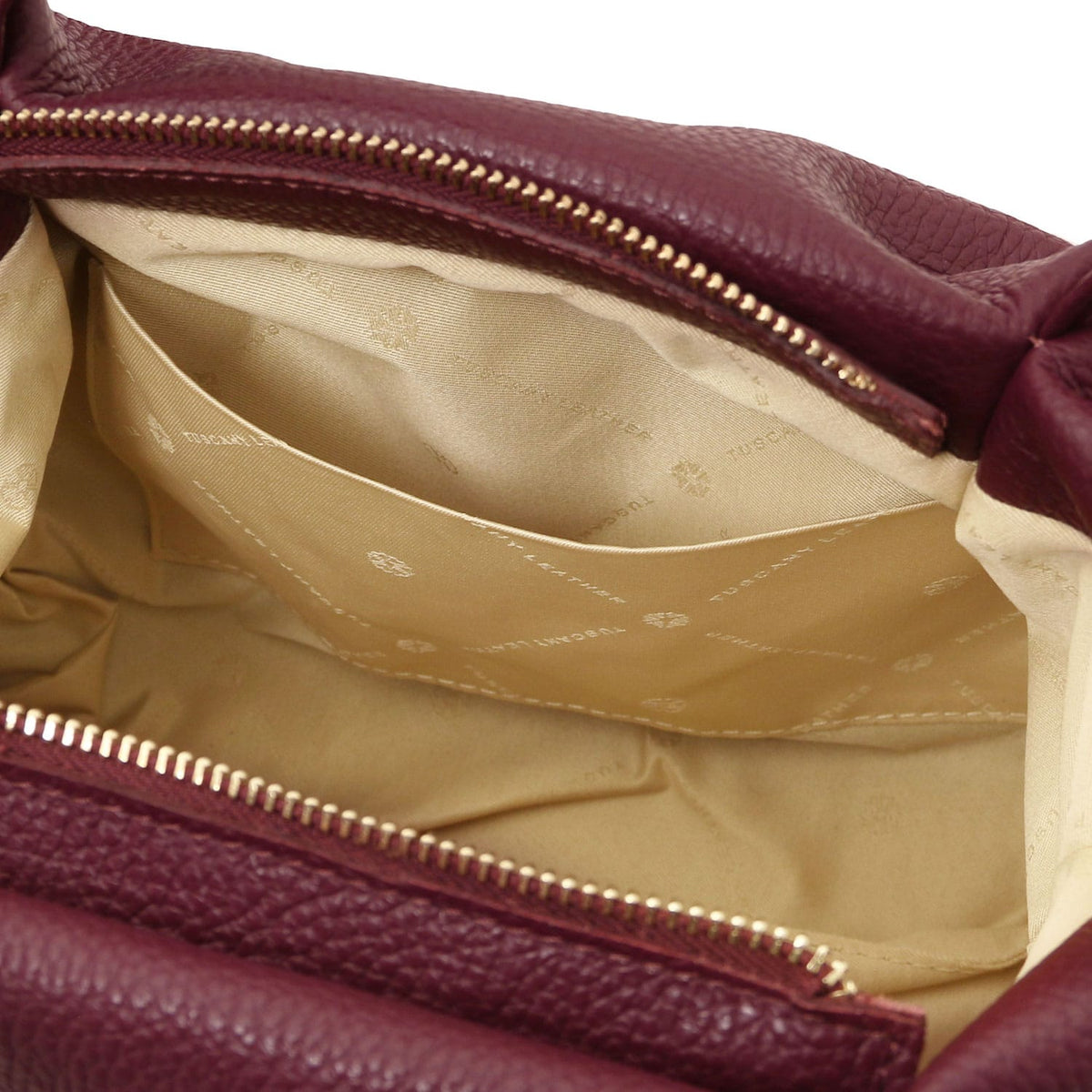 Nora - Soft leather handbag | TL142372 in burgundy pebbled leather with zippered top closure and beige fabric interior lining on white background.