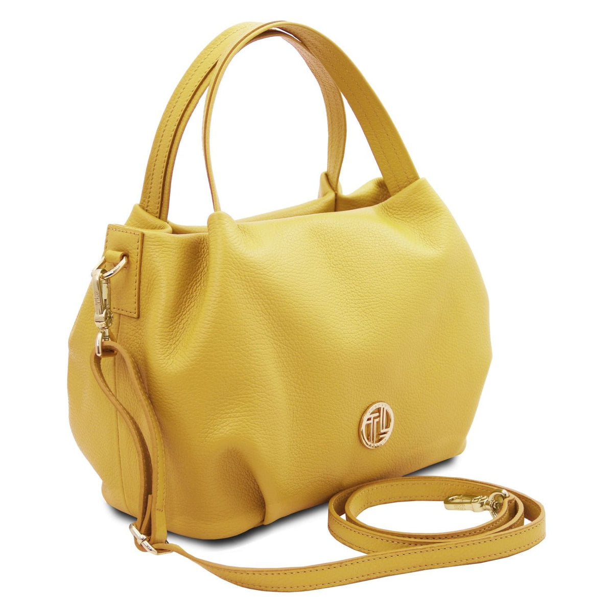 Soft yellow leather handbag with pebbled texture, dual handles, detachable strap, and subtle round metal emblem detail.