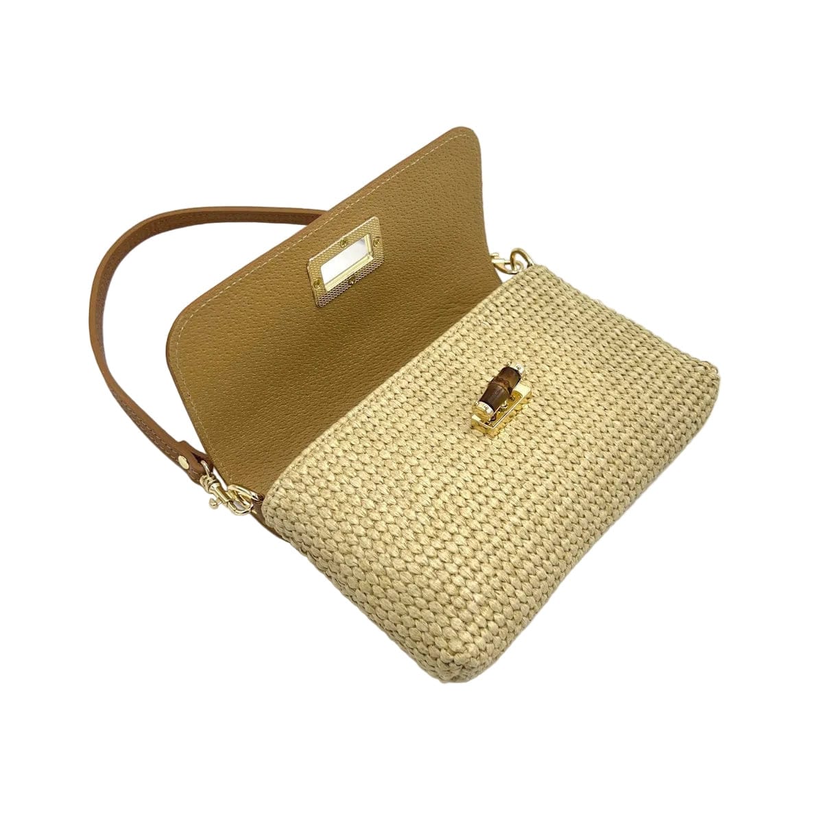 Raffia and leather shoulder bag with the tan flap open, showing the woven raffia body and gold clasp.