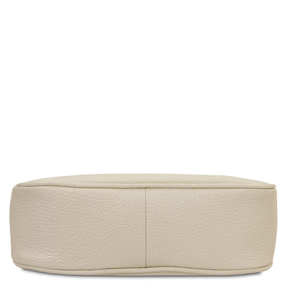 Bottom view of beige pebbled leather clutch showing stitched base seam.