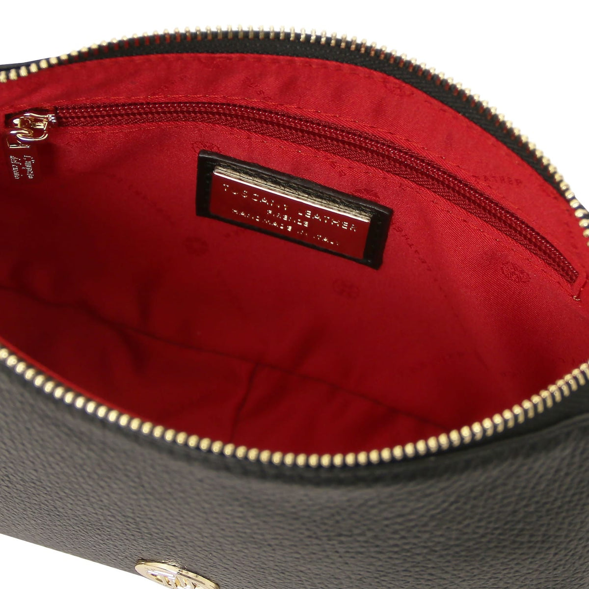 Red lining interior of Parfait clutch with zip pocket and brand label.