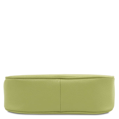 Open lime green leather clutch interior with beige lining, zip pocket, and Tuscan Leather label.